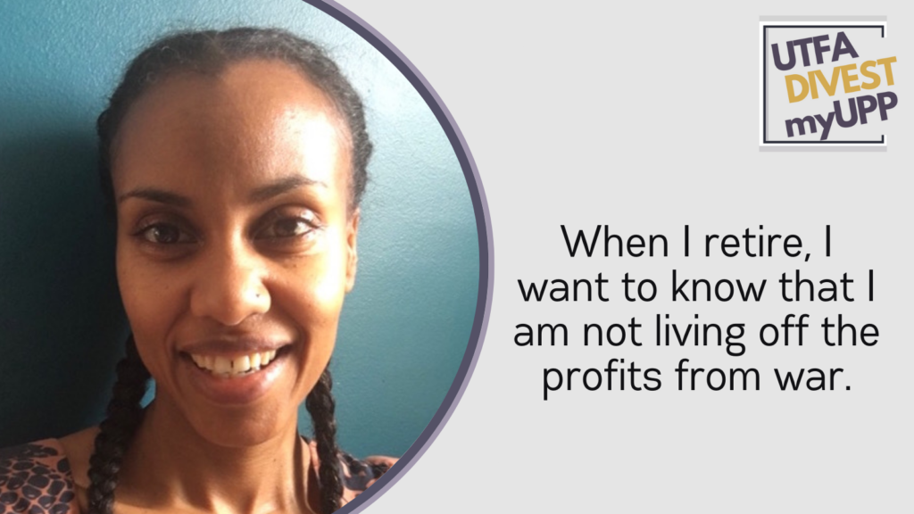 Picture of a Black woman, smiling and looking at the camera, with long braided hair. 